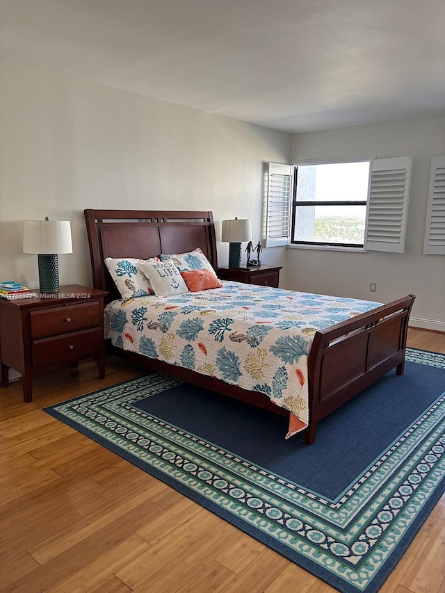 bedroom with hardwood / wood-style floors