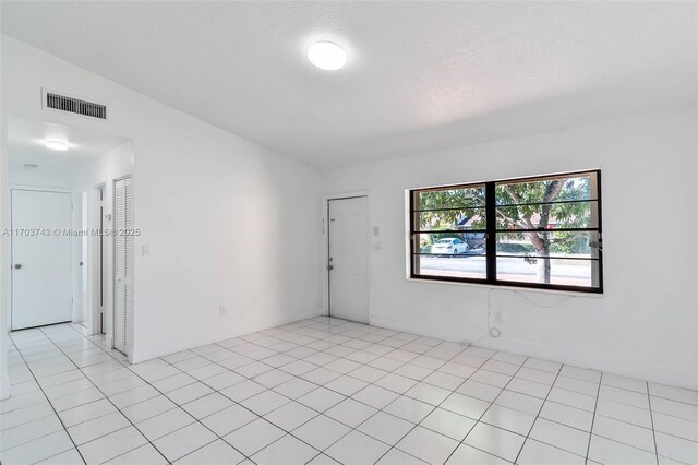 empty room featuring lofted ceiling