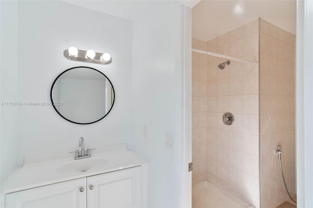 bathroom with vanity and tiled shower