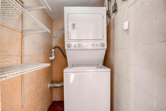 laundry area featuring stacked washing maching and dryer