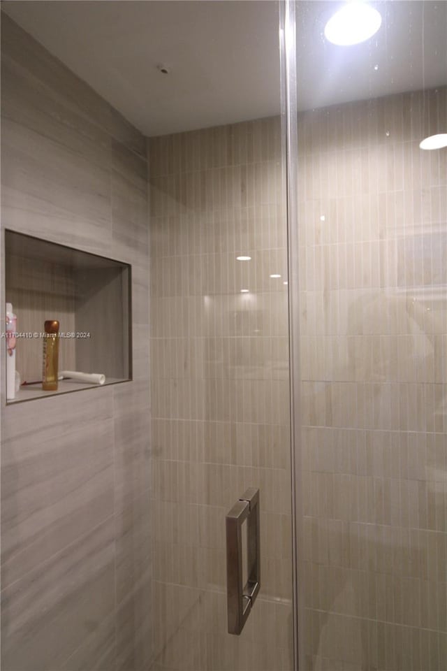 bathroom with a tile shower