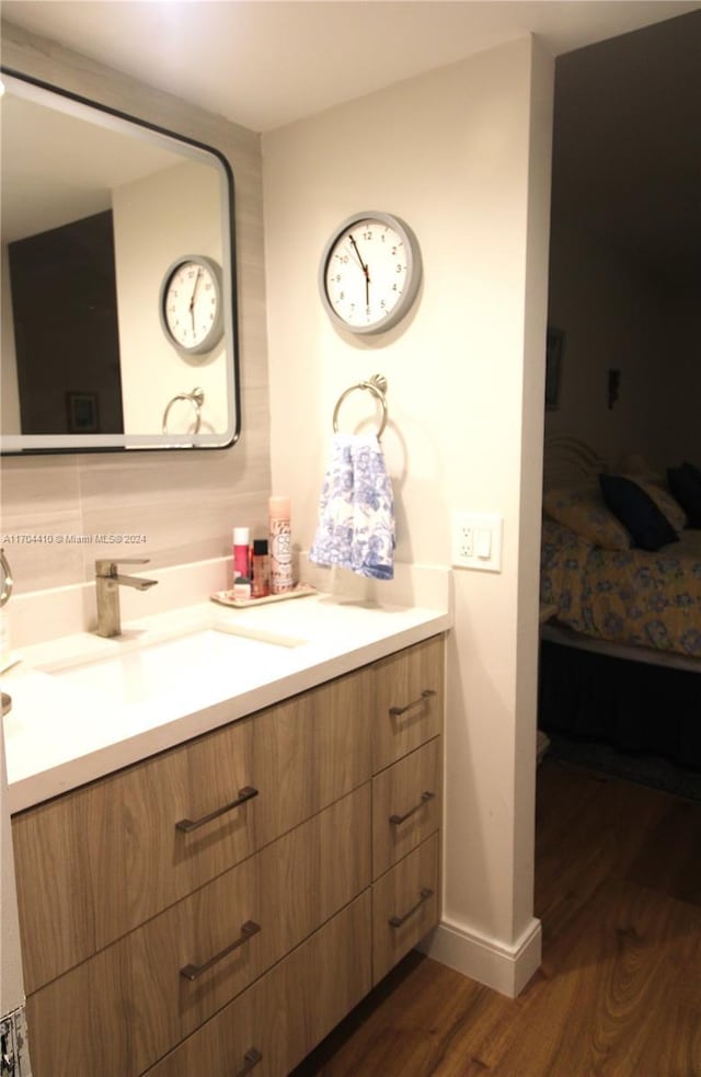 bathroom with hardwood / wood-style flooring and vanity