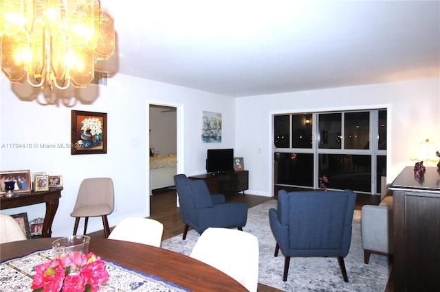 living room with hardwood / wood-style flooring and an inviting chandelier