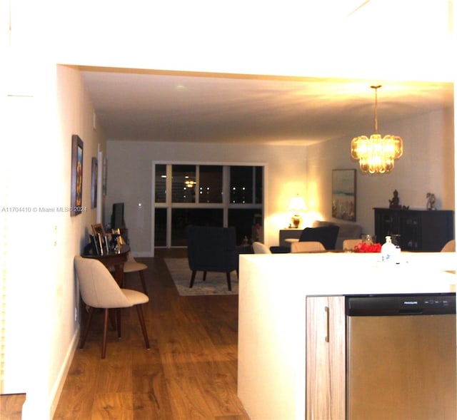 kitchen with dishwasher, hardwood / wood-style floors, decorative light fixtures, and an inviting chandelier