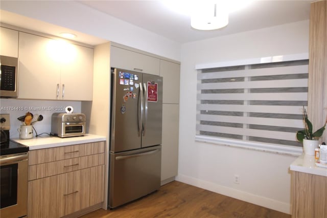 kitchen featuring appliances with stainless steel finishes and wood-type flooring