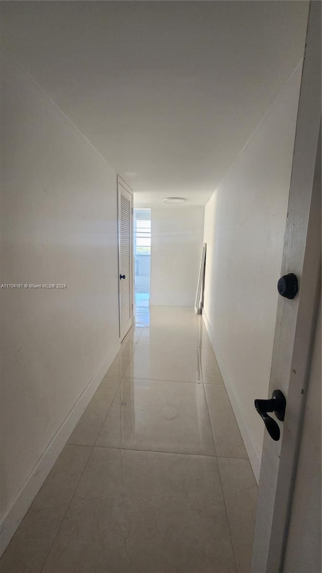 corridor with light tile patterned flooring