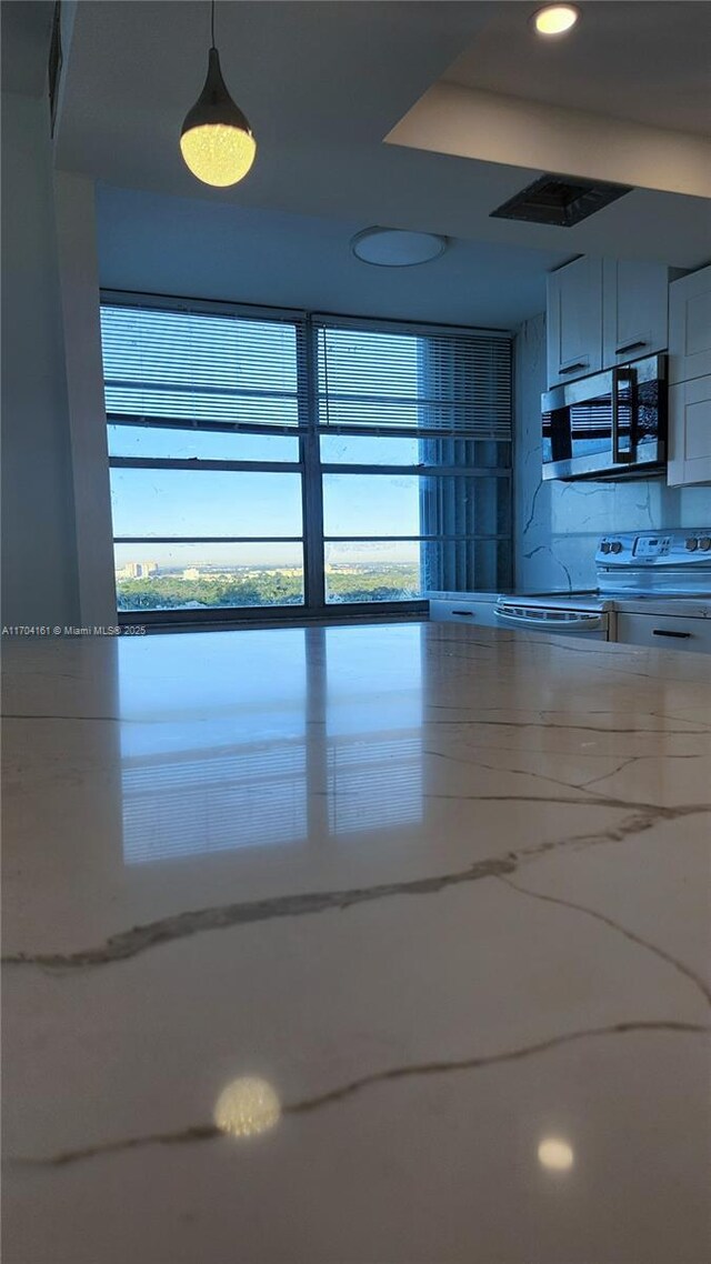 kitchen featuring pendant lighting and range with electric cooktop