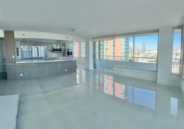 unfurnished living room featuring a wealth of natural light