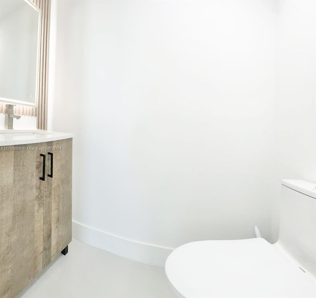 bathroom with concrete floors, toilet, and sink