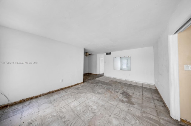 empty room with electric panel and ceiling fan