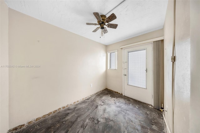 interior space featuring a textured ceiling and ceiling fan