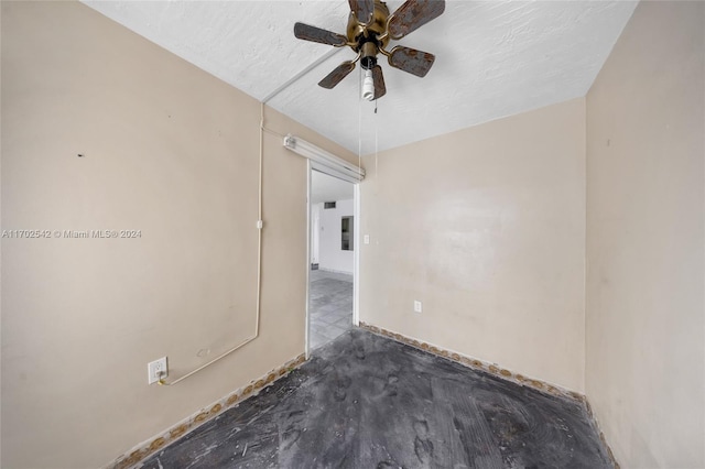 spare room featuring a textured ceiling, ceiling fan, and lofted ceiling