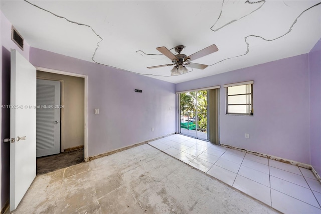 unfurnished room with ceiling fan and light tile patterned flooring