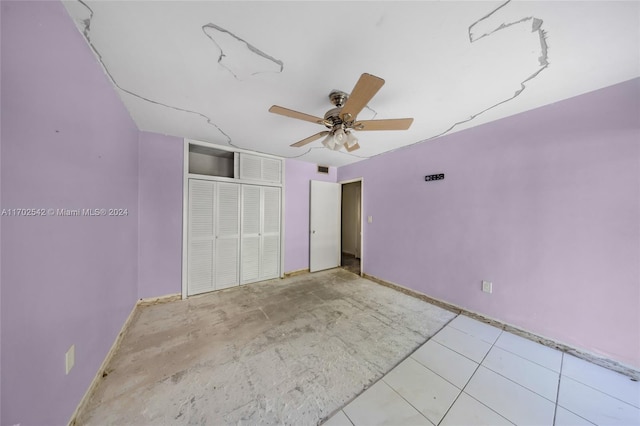 unfurnished bedroom with a closet and ceiling fan