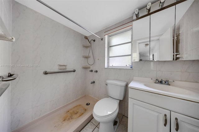 bathroom featuring backsplash, a tile shower, vanity, tile walls, and toilet