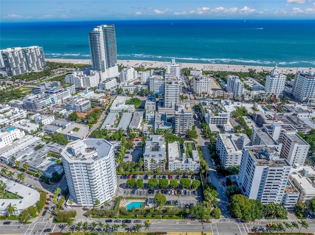 bird's eye view featuring a water view and a beach view