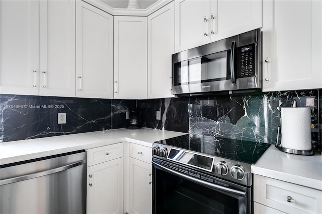 kitchen with appliances with stainless steel finishes, white cabinets, backsplash, and light stone countertops