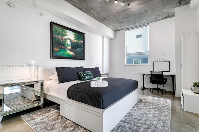 bedroom featuring concrete flooring