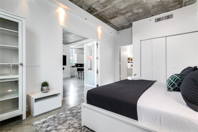 bedroom featuring a closet and concrete floors