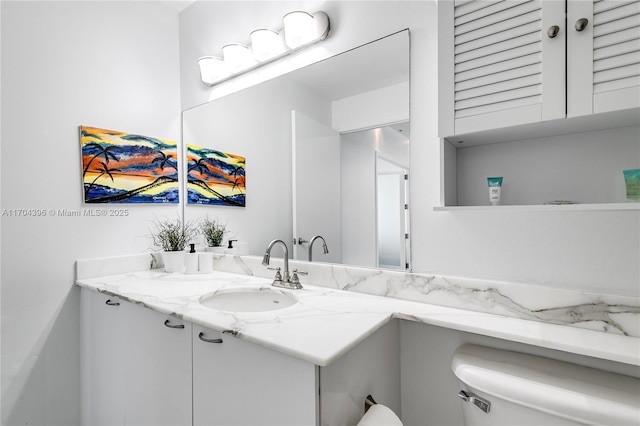 bathroom featuring toilet and vanity