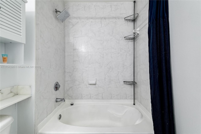 bathroom with toilet and shower / tub combo with curtain