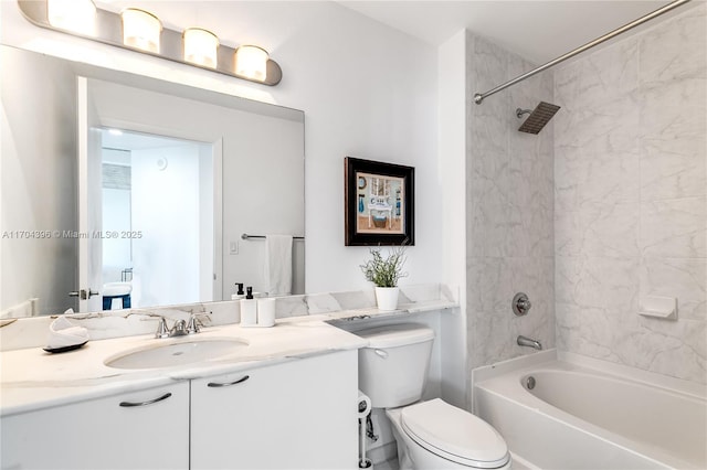 full bathroom featuring tiled shower / bath combo, vanity, and toilet