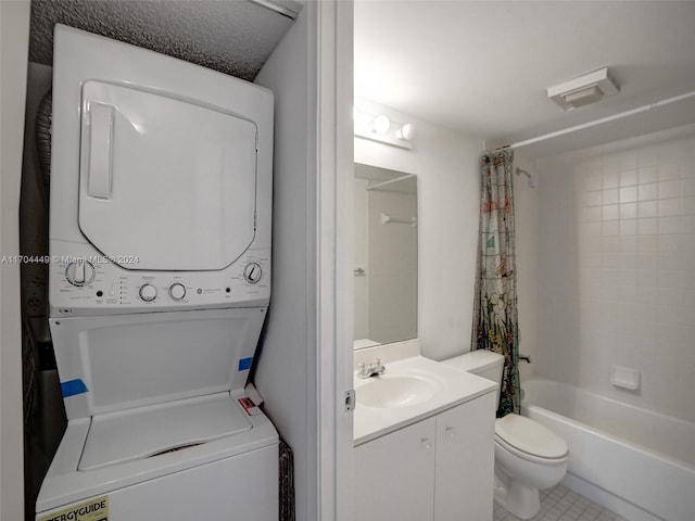 interior space featuring tile patterned flooring, stacked washer / drying machine, and sink