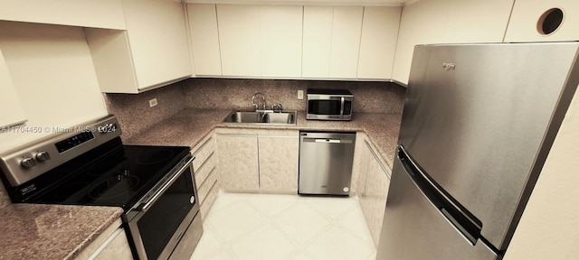 1201 S Ocean Dr Unit 206S, Hollywood, FL 33019 - kitchen with appliances with stainless steel finishes, a sink, tasteful backsplash, and white cabinets