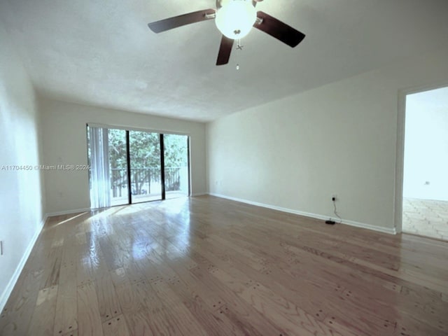 empty room with ceiling fan and light wood-type flooring