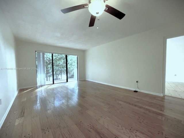 1201 S Ocean Dr Unit 206S, Hollywood, FL 33019 - unfurnished living room with hardwood / wood-style flooring, baseboards, and ceiling fan