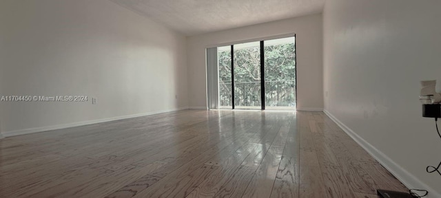 empty room featuring light hardwood / wood-style flooring and lofted ceiling