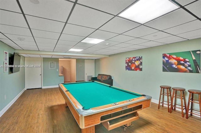 recreation room featuring hardwood / wood-style flooring, a paneled ceiling, and pool table