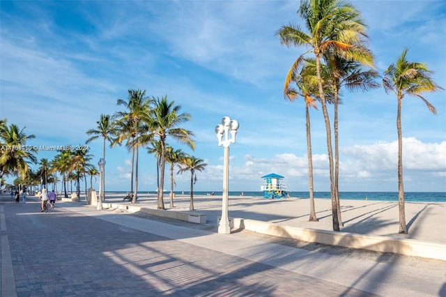 surrounding community featuring a water view and a view of the beach