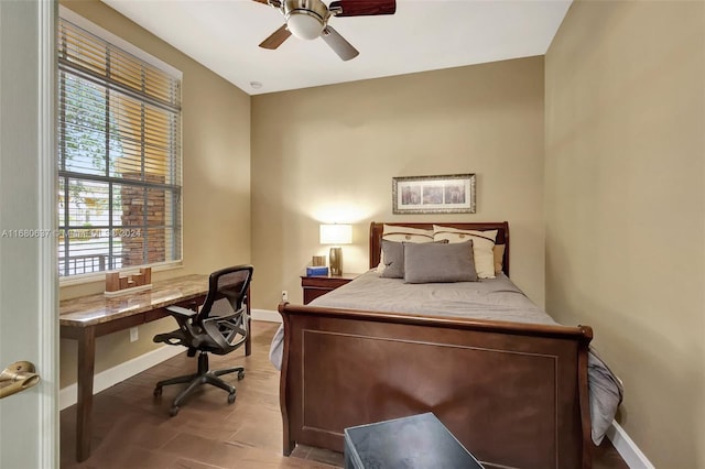 bedroom with multiple windows and ceiling fan