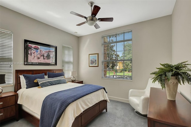 bedroom featuring light carpet and ceiling fan