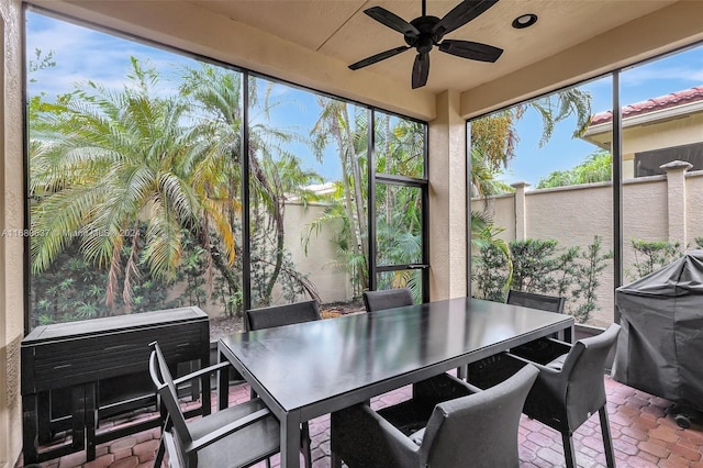 sunroom with ceiling fan and a healthy amount of sunlight