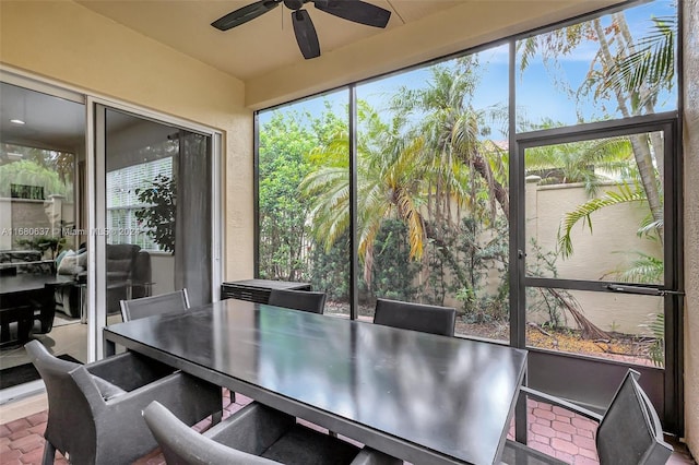 sunroom / solarium with a wealth of natural light and ceiling fan