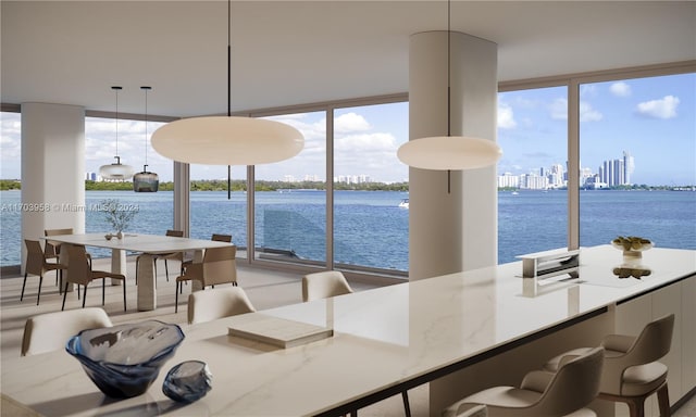 dining room with floor to ceiling windows and a water view