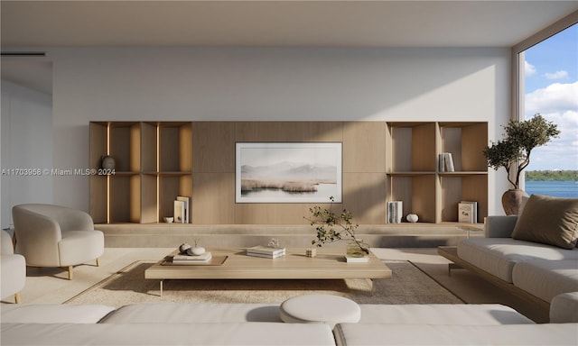 living room with floor to ceiling windows, a water view, and a wealth of natural light