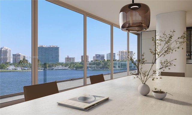 unfurnished sunroom featuring a water view