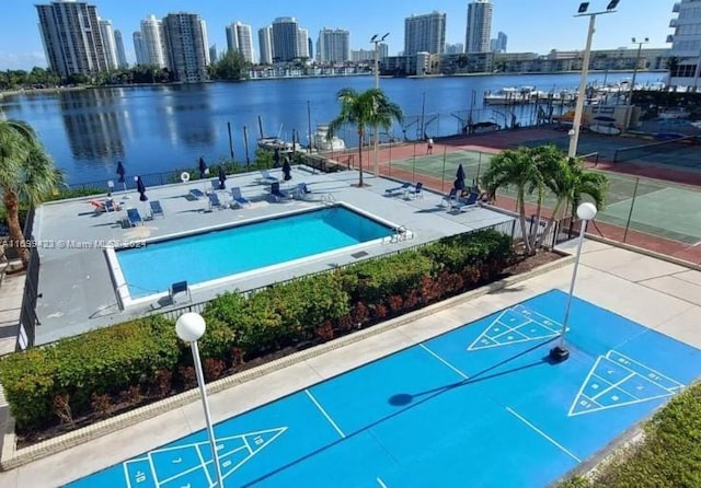 view of swimming pool with a water view