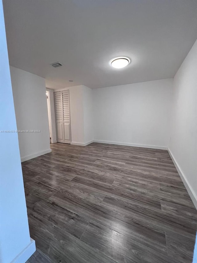 spare room featuring dark wood-type flooring