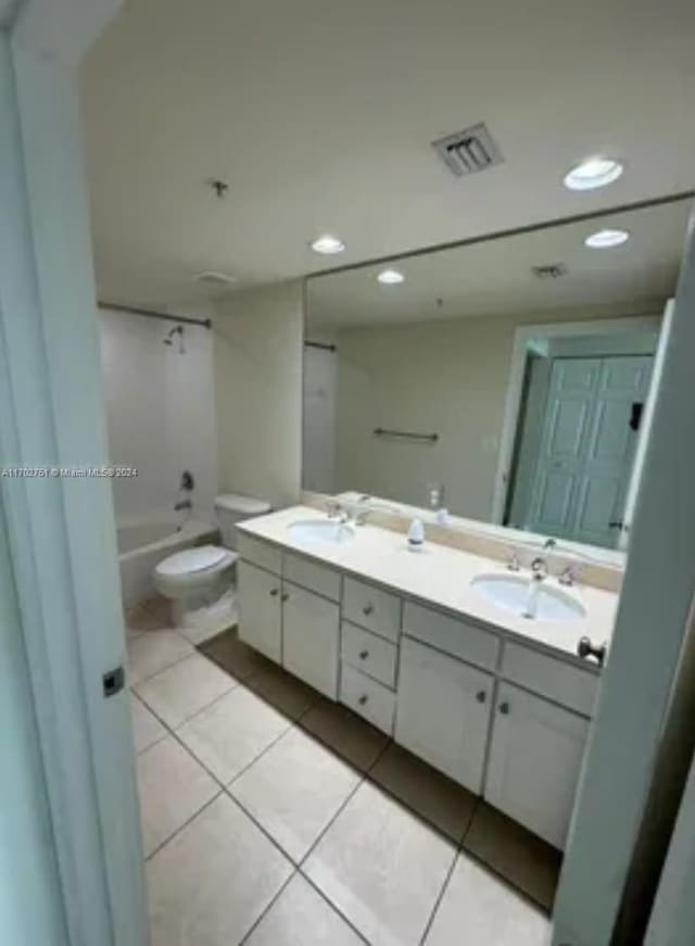 full bathroom with toilet, vanity, tile patterned floors, and tub / shower combination