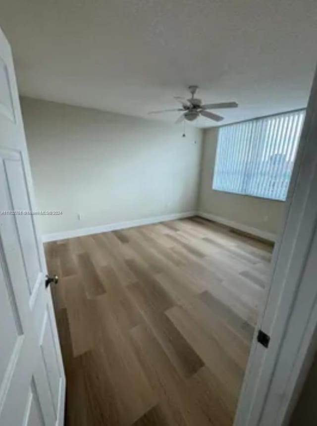 unfurnished room featuring hardwood / wood-style floors and ceiling fan