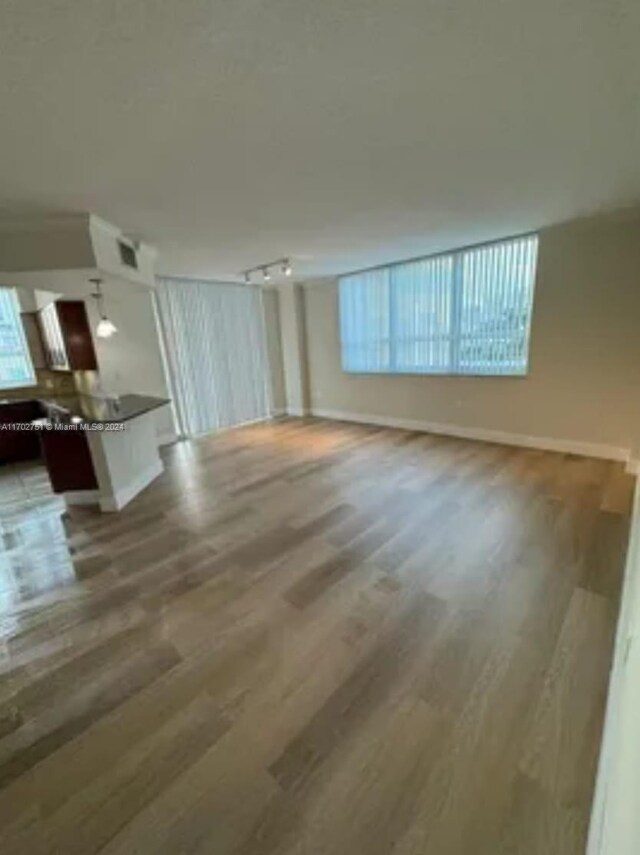 unfurnished living room with hardwood / wood-style flooring