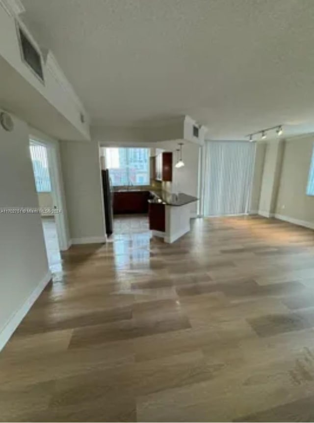 corridor with hardwood / wood-style floors