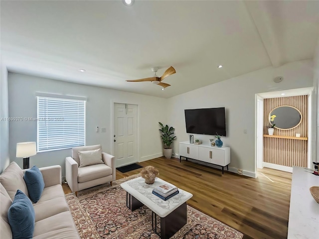 living room featuring hardwood / wood-style flooring, vaulted ceiling, and ceiling fan