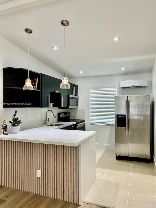 kitchen with appliances with stainless steel finishes, sink, hanging light fixtures, kitchen peninsula, and a wall unit AC