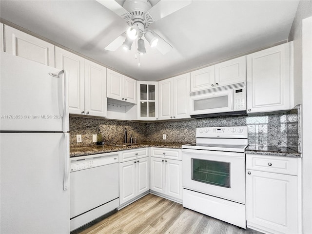 3475 N Country Club Dr Unit 503, Aventura, FL 33180 - kitchen with white appliances, white cabinets, light wood-style flooring, a ceiling fan, and glass insert cabinets