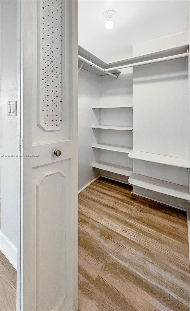 walk in closet featuring hardwood / wood-style flooring